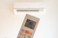 remote control command for air conditioning to be handled point to the device with the order to 25Â°C Royalty Free Stock Photo