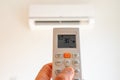 remote control command for air conditioning to be handled point to the device with the order to 30Â°C Royalty Free Stock Photo