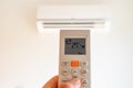 remote control command for air conditioning to be handled point to the device with the order to 27Â°C Royalty Free Stock Photo