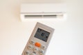 remote control command for air conditioning to be handled point to the device with the order to 18Â°C Royalty Free Stock Photo