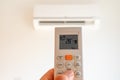 remote control command for air conditioning to be handled point to the device with the order to 28Â°C Royalty Free Stock Photo