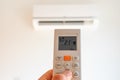 remote control command for air conditioning to be handled point to the device with the order to 21Â°C Royalty Free Stock Photo