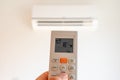 remote control command for air conditioning to be handled point to the device with the order to 18Â°C Royalty Free Stock Photo