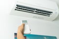 Remote control directed on air conditioner systrem, senior hand control air conditioner at home Royalty Free Stock Photo