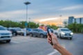 Remote control key Car in hand In the outdoor parking lot at evening Royalty Free Stock Photo