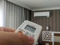 Remote control pointing at air conditioner Royalty Free Stock Photo