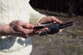 Remote control and smartphone in male hands. A man holding a transmitter and piloting some vehicles. A drone, radio controlled car Royalty Free Stock Photo