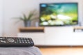 Remote control on the sofa, streaming on a smart TV Royalty Free Stock Photo