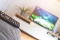 Remote control on the sofa, streaming on a smart TV Royalty Free Stock Photo