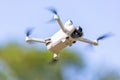 Remote-controlled drone hovers in the sky, capturing aerial footage