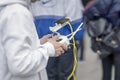 Remote controller, headset with smartphone in hands of teenager, young man close-up, piloting flying copter, drone