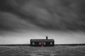 Remote desolate isolated house under dark stormy sky during Winter landscape conceptual image Royalty Free Stock Photo