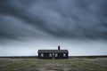 Remote desolate isolated house under dark stormy sky during Wint Royalty Free Stock Photo