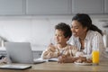 Remote Education. Black Mom And Little Son Using Laptop At Home Together Royalty Free Stock Photo