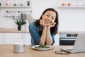 Remote employee sitting at table with laptop and salad Royalty Free Stock Photo