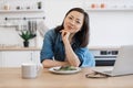 Remote employee sitting at table with laptop and salad Royalty Free Stock Photo