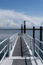 Remote floating landing stage for a ferry boat or jetty at a calm sea with an impressinve cloudy sky Royalty Free Stock Photo