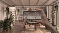 Remote home control system on a digital smart phone tablet. Device with app icons. Interior design of modern conservatory, winter