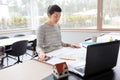 Young woman with blueprint working at home office Royalty Free Stock Photo