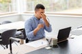 Tired man with laptop working at home office Royalty Free Stock Photo