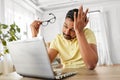 Stressed man with laptop working at home office Royalty Free Stock Photo