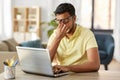 Tired man with laptop working at home office Royalty Free Stock Photo