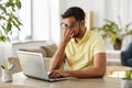 Tired man with laptop working at home office Royalty Free Stock Photo