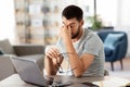 Tired man with laptop working at home office Royalty Free Stock Photo