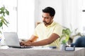 Man with laptop and papers working at home Royalty Free Stock Photo