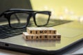 REMOTE LEARNING virtual learning concept with wood block letters on laptop Royalty Free Stock Photo
