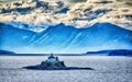 remote lighthouse island standing in the middle of mud bay alaska