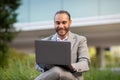 Remote Office. Happy Young Businessman Using Laptop While Sitting Outdoors Royalty Free Stock Photo