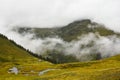 Hut in high mountain landscape, foggy fall season landscape Royalty Free Stock Photo