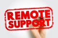 Remote Support written in bold stamp style text with a hand holding a marker, representing online troubleshooting, virtual Royalty Free Stock Photo