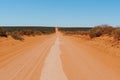 Dusty Australian outback red road and bush, Western Australia Royalty Free Stock Photo