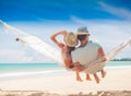 Young couple in love relaxing in a hammock by the beach Royalty Free Stock Photo