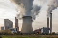 Remote view of a brown coal power plant with its cooling towers and chimneys Royalty Free Stock Photo