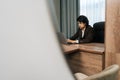 Remote view of focused busy businessman in suit typing on laptop at workplace. Company leader, boss, CEO using online Royalty Free Stock Photo