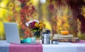 Remote work in autumn. Cozy fall workspace with laptop outdoors. Fall freelance setup with laptop. Laptop on cozy fall table Royalty Free Stock Photo