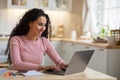 Remote Work. Beautiful Young Freelancer Lady Working With Laptop In Kitchen