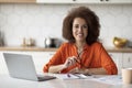 Remote Work. Black Female Freelancer Sitting At Desk With Laptop In Kitchen Royalty Free Stock Photo