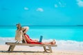 Remote work concept -young woman with laptop on beach Royalty Free Stock Photo