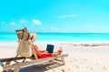 Remote work concept -young woman with laptop on beach Royalty Free Stock Photo