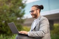 Remote Work. Handsome young businessman using laptop outdoors Royalty Free Stock Photo