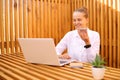 Remote work or outdoor education. Pretty stylish young brown haired woman wearing white shirt, using voice message on smartphone Royalty Free Stock Photo