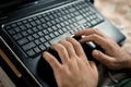 Remote work during quarantine. A man works at a laptop, closeup keyboard. Horizontal frame