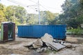 Removal of debris construction waste building demolition with rock and concrete rubble on portable bio-toilets