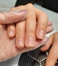 Removal of gel polish from nails by a master. Removing the coating from the nails. Royalty Free Stock Photo
