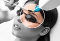 Removal of permanent makeup on the eyebrows of a woman.Carbon face peeling in a beauty salon. Hardware cosmetology treatment Royalty Free Stock Photo