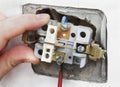 Removal and replacement of the old, faulty wall switch light. Royalty Free Stock Photo